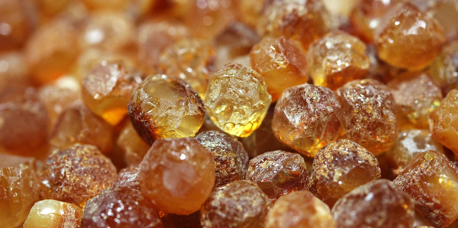 Close-up of amber-colored gemstones with a soft focus
